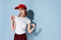 young woman in red cap summer fashion posing  background Royalty Free Stock Photo