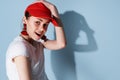 young woman in red cap summer fashion posing isolated background Royalty Free Stock Photo