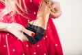 Woman in red dott dress holding tan vintage stockings Royalty Free Stock Photo