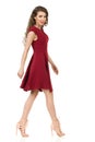 Beautiful Woman In Red Dress And High Heels Is Walking. Side View. Royalty Free Stock Photo