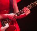 Young woman in red dress and guitar Royalty Free Stock Photo