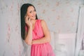 Young woman in red dress phone talking. Smartphone call. Girl smail and talk with mobile