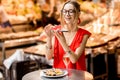 Woman eating mussels at the food market