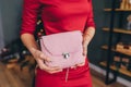 Young woman in red dress with pink knitted purse or bag