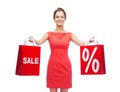 Young woman in red dress with shopping bags Royalty Free Stock Photo