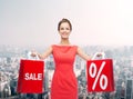 Young woman in red dress with shopping bags Royalty Free Stock Photo