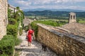 Young woman with red dress in the village of Joucas