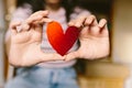 Young woman with red glitter heart shaped cardboard on the hands. Girl holding a cardboard heart for st. valentine`s day. Love an