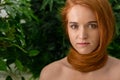 Young woman with red hair around neck as scarf Royalty Free Stock Photo