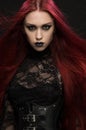 Young woman with red hair in black gothic costume Royalty Free Stock Photo