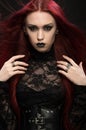 Young woman with red hair in black gothic costume Royalty Free Stock Photo