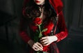 Young woman red hood. Vampire lips dripping blood. bloody lips halloween rose