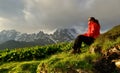 Young woman in red jacket enjoy sunset in mountains Royalty Free Stock Photo