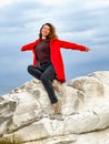 girl in a red jacket on the seashore