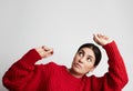 Young woman in red jumper making funny face. Horizontal. Royalty Free Stock Photo