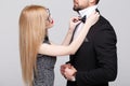 Young woman with red lips straighten man bow tie Royalty Free Stock Photo