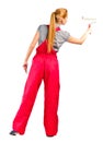 Young woman in red overalls with painting tools Royalty Free Stock Photo