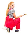 Young woman in red overalls with painting tools Royalty Free Stock Photo