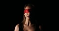 Young woman with red ribbon on her eyes Royalty Free Stock Photo