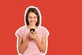 Young woman in a red striped t-shirt looks at the phone and smiles, good news, joy. emotional girl Magazine collage style with Royalty Free Stock Photo