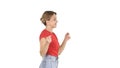 Young woman in red t-shirt, jeans dancing and walking on white background. Royalty Free Stock Photo