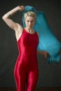 Young woman in red unitard waving a blue scarf. Royalty Free Stock Photo