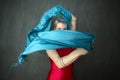 Young woman in red unitard waving a blue scarf. Royalty Free Stock Photo