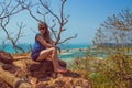 Young woman at Redi fort. View on Shiroda beach in the state of