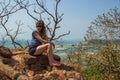 Young woman at Redi fort. View on Shiroda beach in the state of