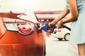 Young woman refuels herself in a large, modern gas station during her travels. Royalty Free Stock Photo