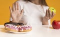 Young Woman Refusing Sweets And Choosing Healthy Fruits