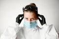 Young woman regulate medical mask with her hands