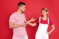 Young woman rejecting engagement ring from boyfriend on background