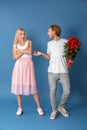 Young woman rejecting marriage proposal on color background Royalty Free Stock Photo
