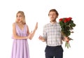 Young woman rejecting marriage proposal on white background Royalty Free Stock Photo