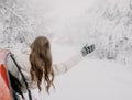 A young woman rejoices at the coming of winter. Winter forest