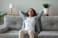 Young woman relax on comfortable sofa breathing fresh air Royalty Free Stock Photo