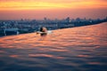 Young woman relax in swimming pool on roof top during amazing sunset and enjoy cityscape Royalty Free Stock Photo