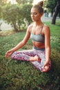 Young woman relax in yoga pose on the grass Royalty Free Stock Photo