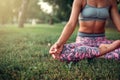 Young woman relax in yoga pose on the grass Royalty Free Stock Photo