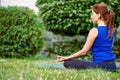 Young woman relaxes practicing advanced yoga