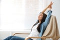 Young woman relaxing in armchair near window Royalty Free Stock Photo