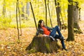 Young woman relaxing in the autumn park Royalty Free Stock Photo