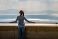 Young woman relaxing on balcony of castle on mediterranean sea. Royalty Free Stock Photo