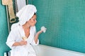 Young woman relaxing bathroom foam bathtub wine Royalty Free Stock Photo