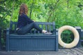 Young woman relaxing on bench in nature Royalty Free Stock Photo