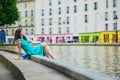 Young woman relaxing on Canal Saint Martin on a summer day in Paris, France