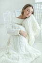 Young woman relaxing with chunky wool blanket. Relax, comfort lifestyle. Winter style. Royalty Free Stock Photo