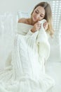 Young woman relaxing with chunky wool blanket. Relax, comfort lifestyle. Winter style. Royalty Free Stock Photo