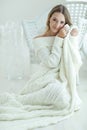 Young woman relaxing with chunky wool blanket. Relax, comfort lifestyle. Winter style. Royalty Free Stock Photo